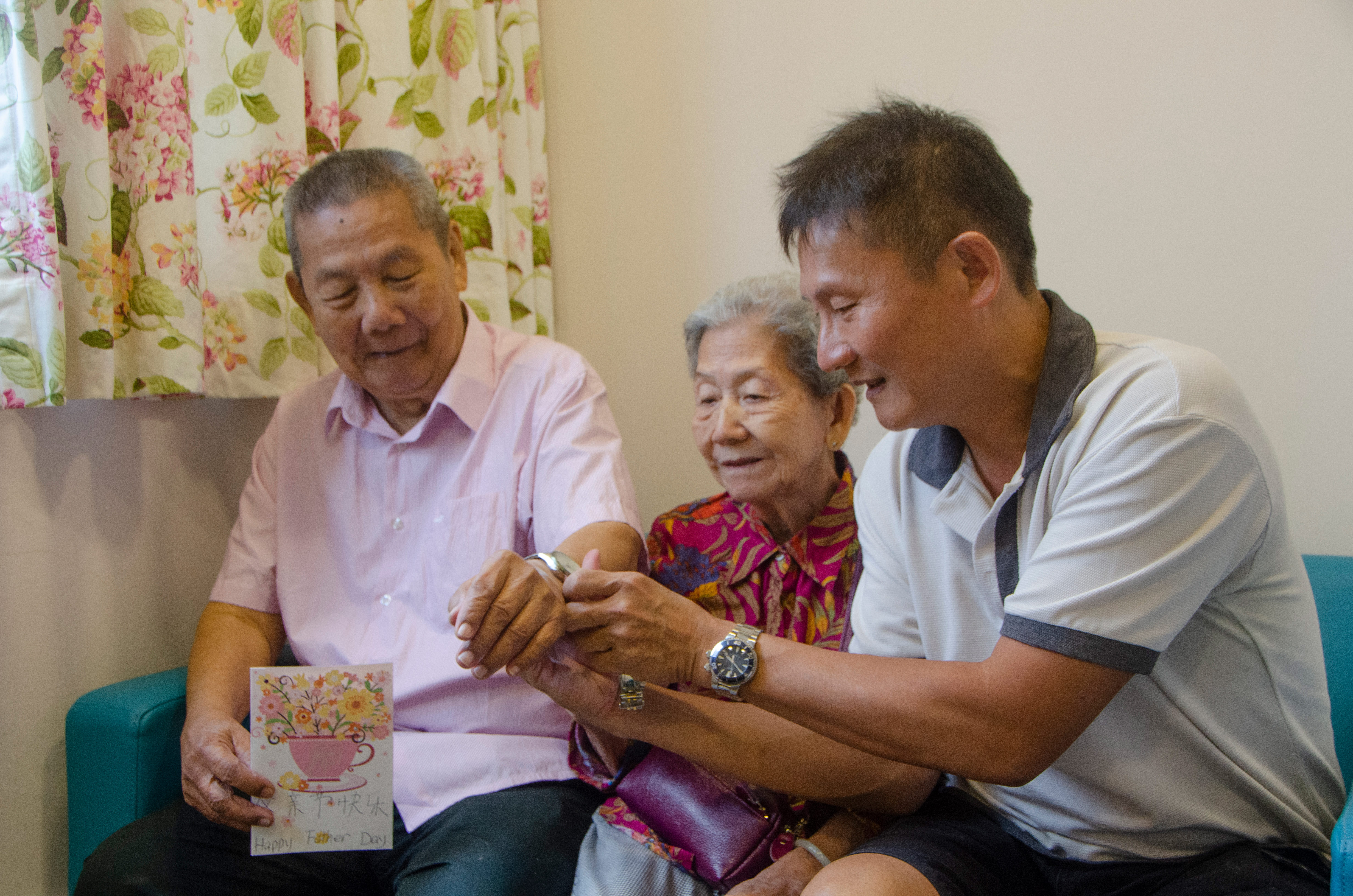 Mr Tan surprising his dad with a gift