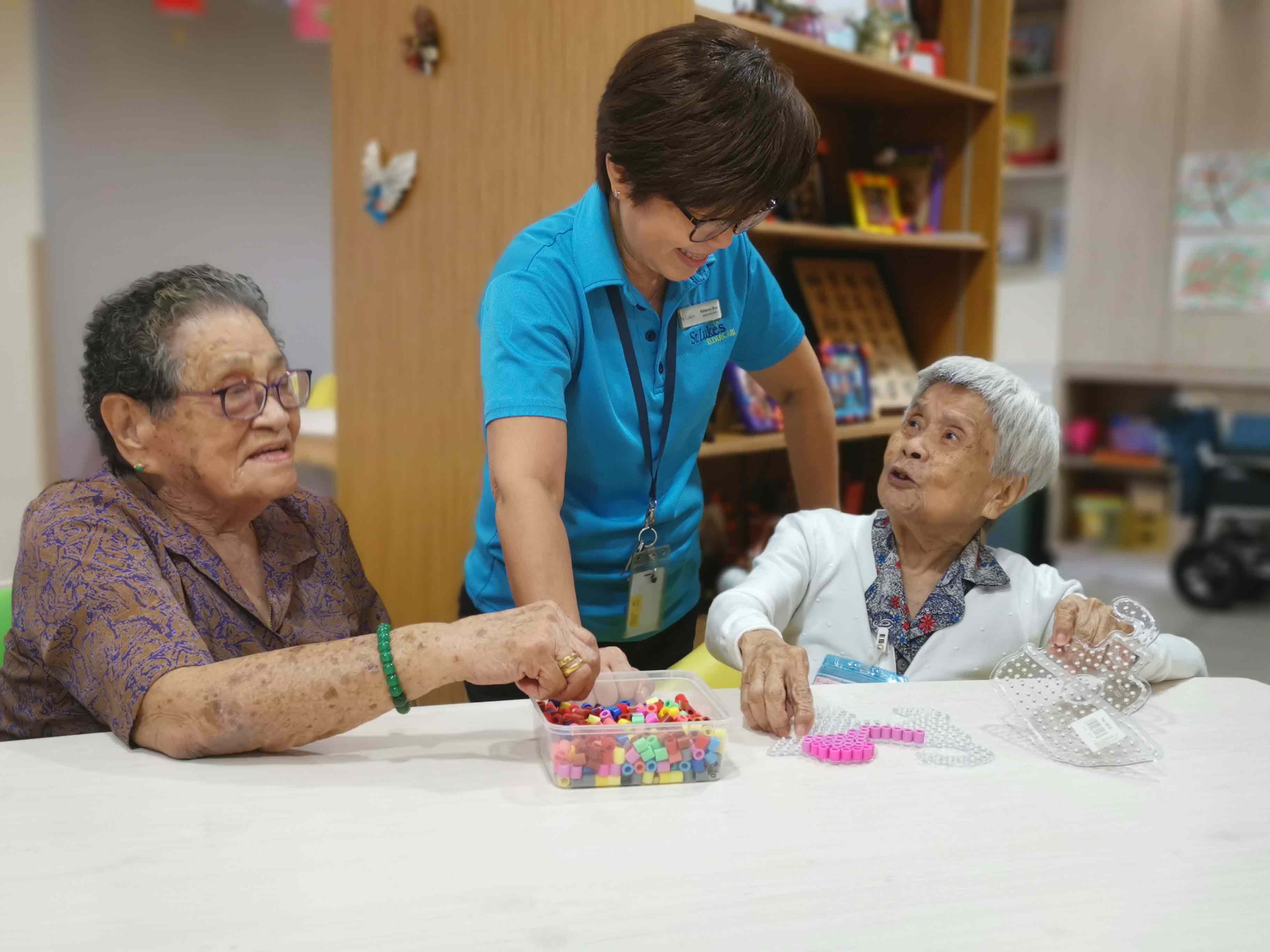 Mdm Lim and Mdm Yeo interacting with sons and care staff